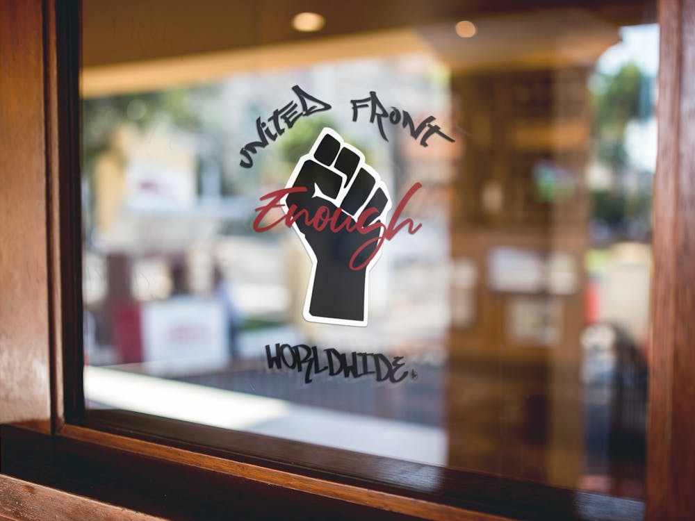 The logo for the United Front Worldwide (UFW) is displayed outside of a business. The logo indicates that a business has taken the pledge. Photo courtesy of Al Howard.
