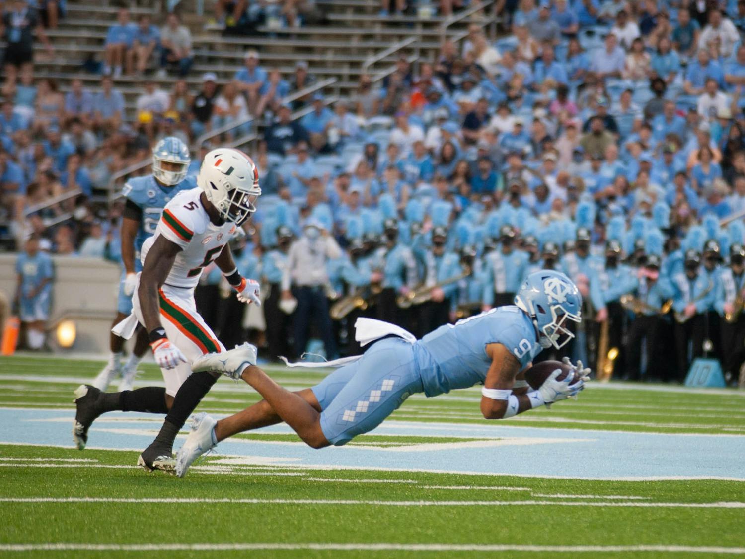 Junior defensive back Cam'Ron Kelly (9) receives the ball during the Tar Heels' football game at Kenan Stadium on Oct. 16 against Miami. UNC won 45-42.