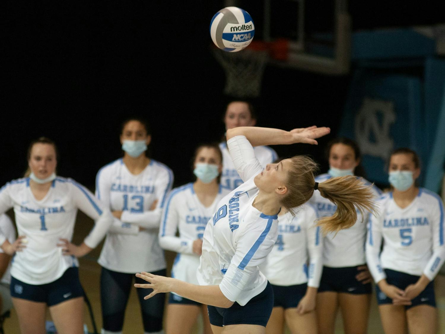 UNC freshman outside hitter Mabrey Shaffmaster serves the ball as her teammates look on during the Tar Heels' home matchup against Elon on Sept. 14, 2021. The Heels won 3-0. 