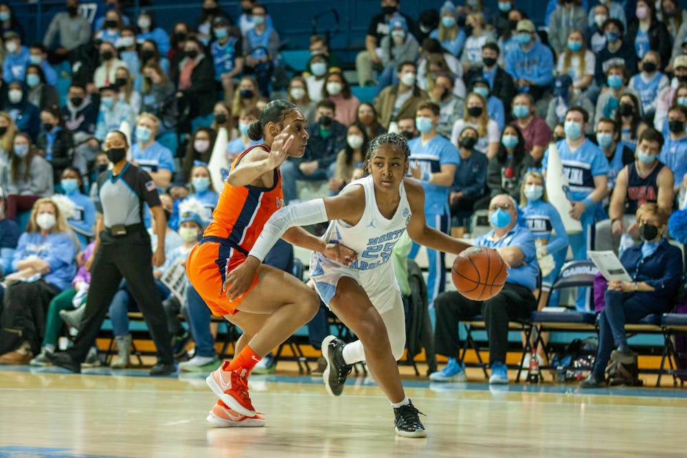 <p>Sophomore guard Deja Kelly (25) runs with the ball at the game against Virginia on Jan. 20, 2022 at Carmichael Arena. UNC won 61-52.</p>