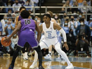UNC sophomore guard Caleb Love (2) plays defense during a home game at the Dean Smith Center against Furman on Tuesday, Dec. 14, 2021.