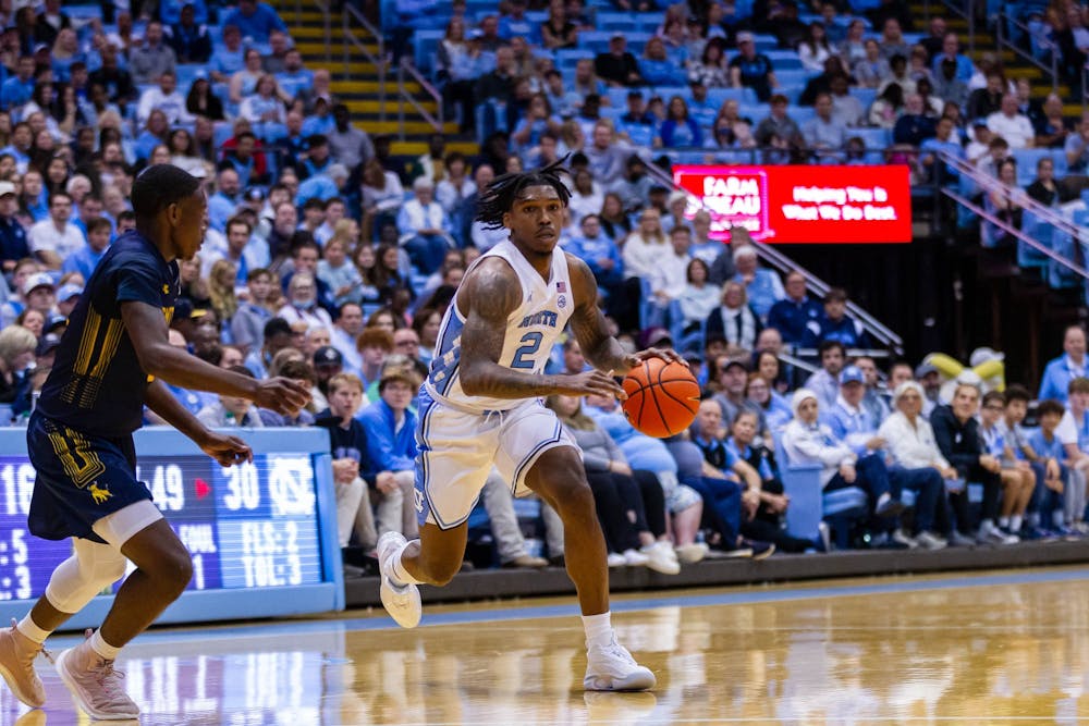 UNC junior guard Caleb Love (2) dribbles the ball away from his opponent during the exhibition game against JCSU at the Dean Smith Center on Friday, Oct. 28, 2022. UNC beat JCSU 101-40.