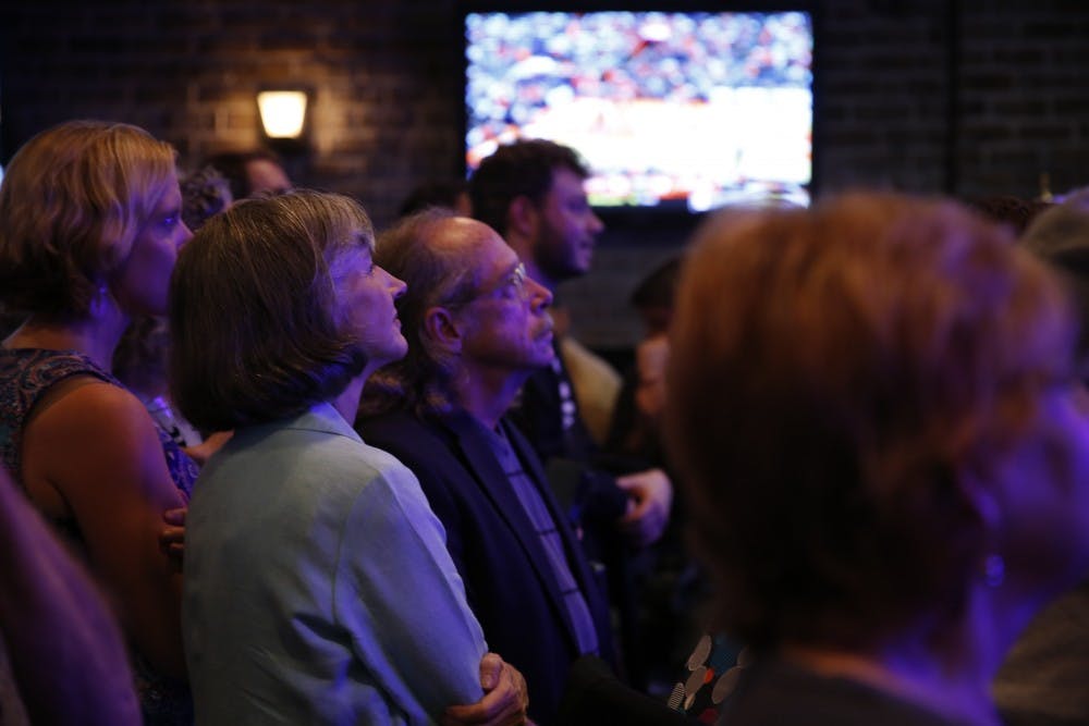 Sally Greene, the democratic candidate for Board of Commissioners, looks on to voting updates at Orange County's Democratic Party's election party at Might as Well in Chapel Hill.