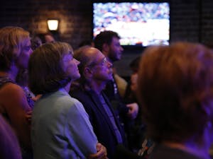 Sally Greene, the democratic candidate for Board of Commissioners, looks on to voting updates at Orange County's Democratic Party's election party at Might as Well in Chapel Hill.