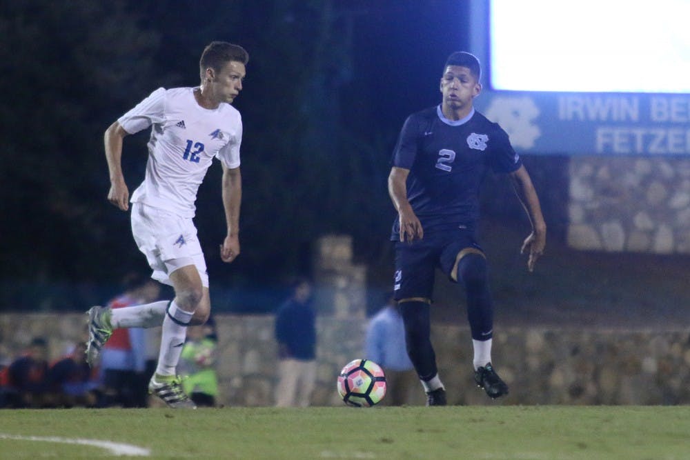 Defender Mauricio Pineda runs against a UNC Asheville player during the game on Tuesday. 