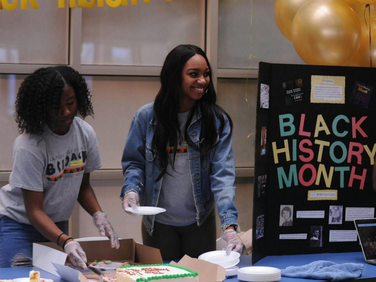 UNC sophomores Jasmine Marshall and Faith Jeffers help the Black Student Movement kickoff Black History Month in the Carolina Union on Friday, Feb. 1, 2019.