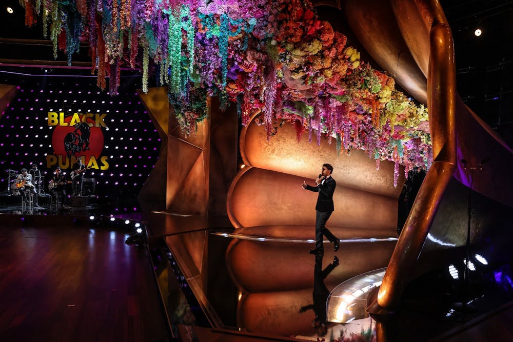 Trevor Noah emerges from a flower-adorned gramophone during a pretaped segment for the 63rd Grammys at the Los Angeles Convention Center on March 11, 2021. Photo courtesy of Robert Gauthier/Los Angeles Times/TNS.