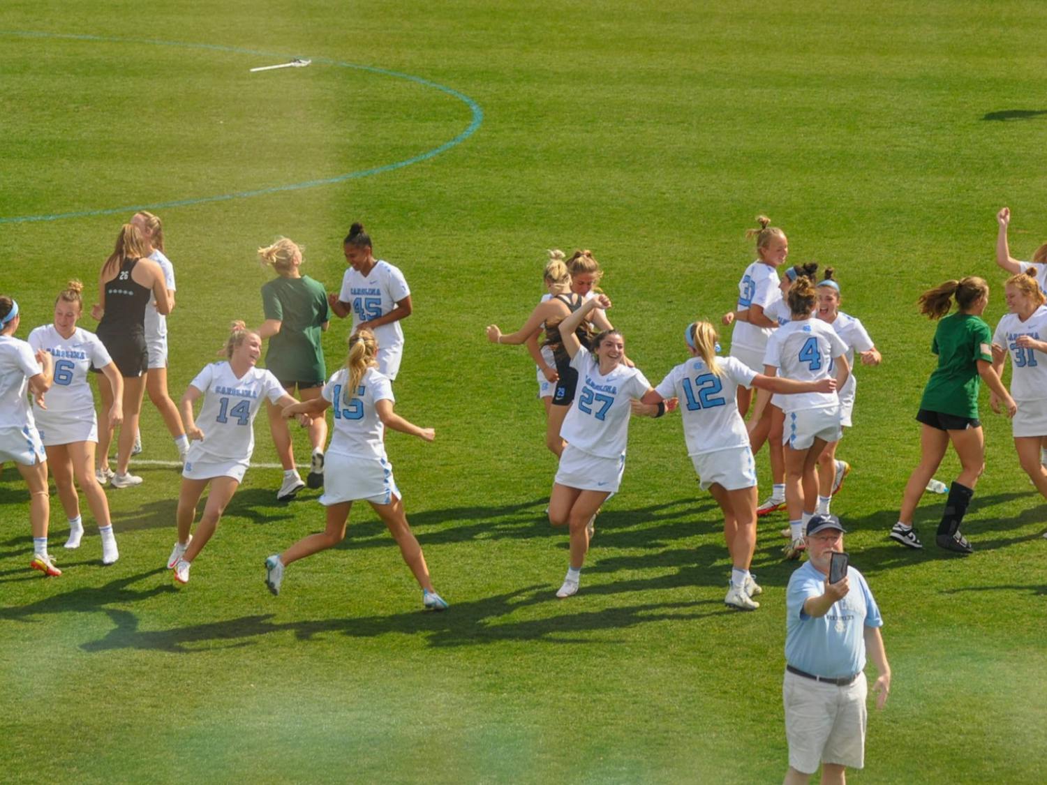Members of the UNC women’s lacrosse team dance &nbsp;to the fight song after defeating Northwestern, 20-9, on Sunday, March 6, 2022.