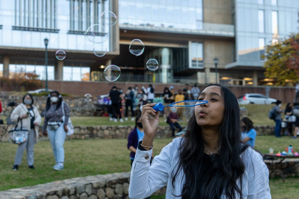 Anvita Godavarthi, a second-year student majoring in Business Administration, participates in various activities including blowing bubbles on the Wellness Field Day on Nov. 12.