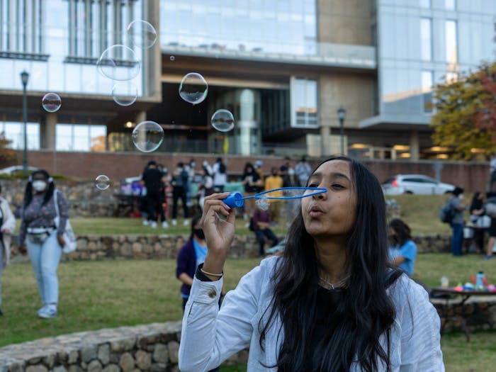 Anvita Godavarthi, a second-year student majoring in Business Administration, participates in various activities including blowing bubbles on the Wellness Field Day on Nov. 12.