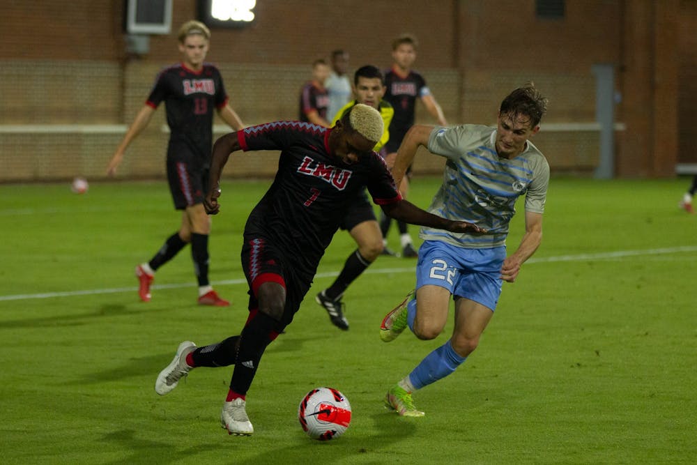 UNC senior midfielder Milo Garvanian (22) attempts to defend the ball during the match against Loyola Marymount on Oct. 19. The Tar Heels defeated the Lions 2-0.