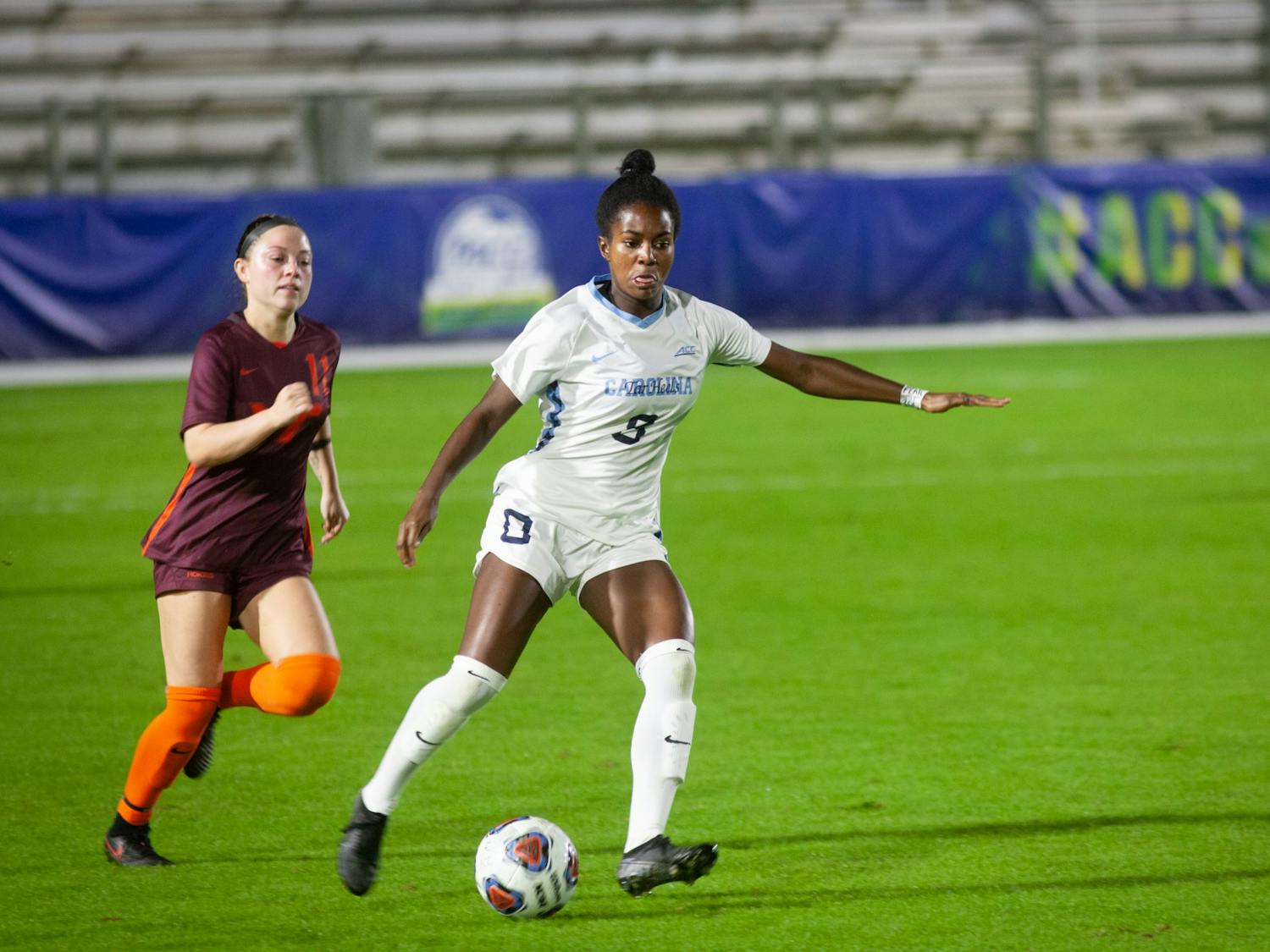 UNC junior midfielder Brianna Pinto (8) dribbles past Virginia Tech junior midfielder Grace Sklopin (11) during the first round of the ACC Tournament on Tuesday, Nov. 10, 2020 at the WakeMed Soccer Park. The Heels beat the Hokies 1-0.