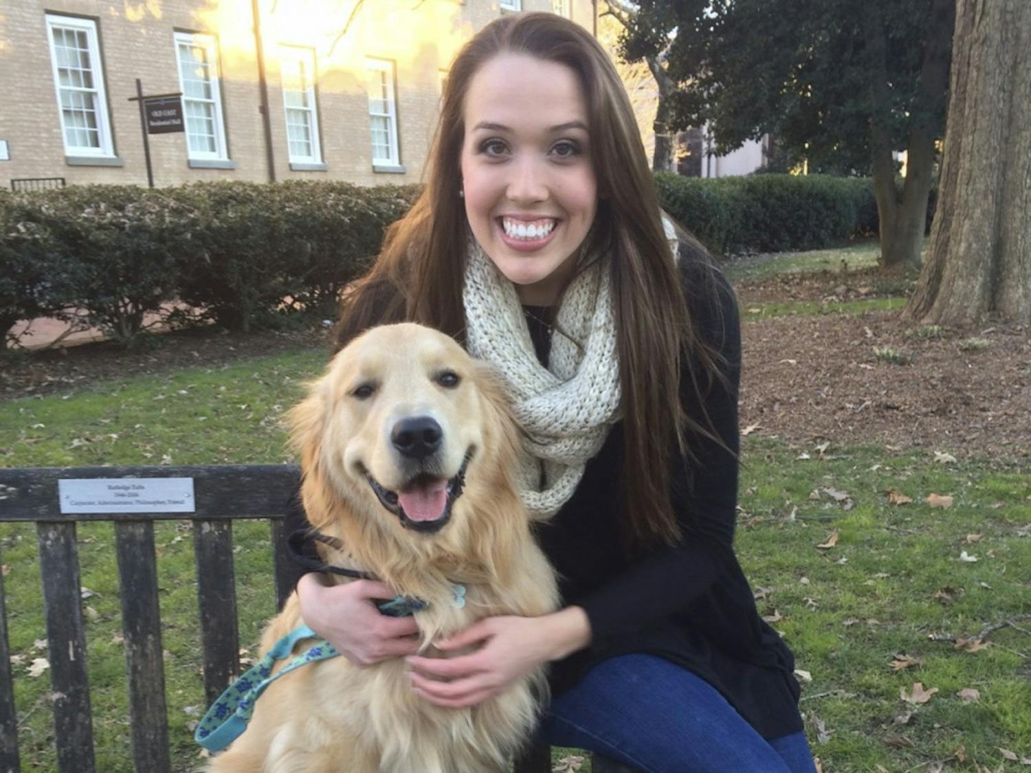 Holden the Golden poses with his owner, UNC senior Caroline Bowers. Holden is in the process of completing an 11 item UNC bucket list and has one semester left.