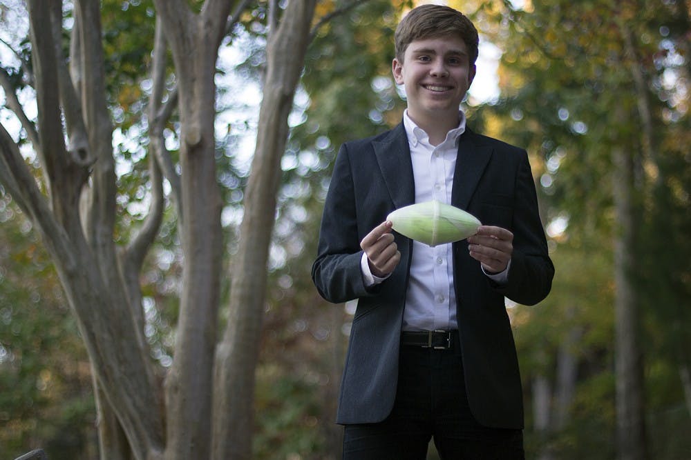 Chase Lewis, 15, winner of the Big Hero 6 XPRIZE Challenge, holds his winning Emergency Mask Pod, a football-shaped pod whose contents include smoke goggles and mask. He designed it to be thrown into burning buildings.