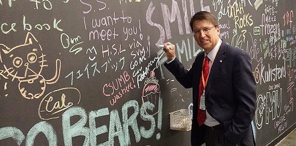 	Governor Pat McCrory signs Facebook’s wall at their headquarters in Menlo Park, Calif. on Monday during a visit focused on job creation. Courtesy of Ryan Tronovitch.