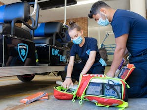 UNC Senior Ishan Khosla and Junior Sarah Torzone show what is kept in their emergency kit on Wednesday, Oct. 20, 2021.