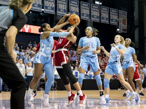 UNC junior guard Deja Kelly (25) makes a strong defensive effort against NC State in the women's basketball game at Carmichael Arena on Sunday, Jan. 15, 2023. UNC won 56-47.