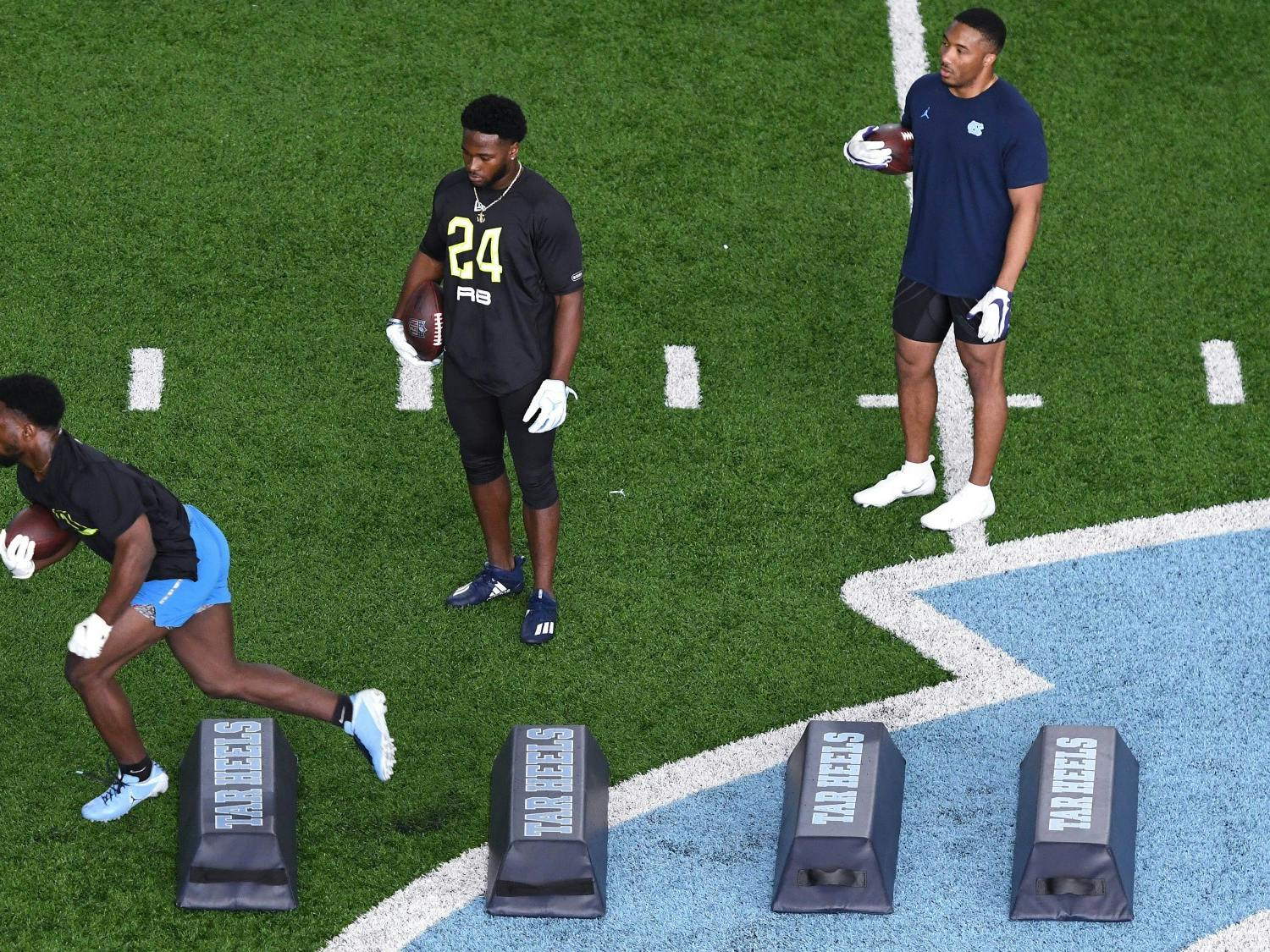 Michael Carter, Javonte Williams, Jordan Brown drill during University of North Carolina Football's Pro Day at the Indoor Practice Facility on Monday, March 29, 2021. Photo courtesy of Jeff Camarati. 
