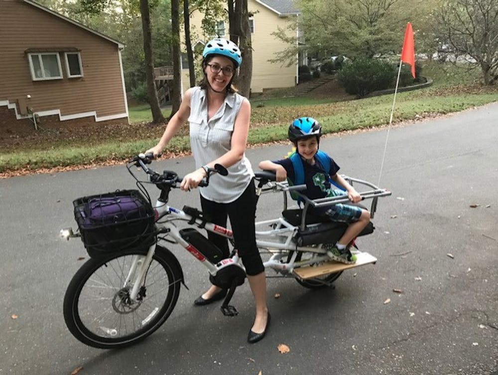 For Laura Sandt of Carrboro, cargo biking replaced more than just a few trips. She uses it to take her children to school and to go to work. Photo courtesy of Heidi Perov Perry. 