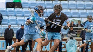 UNC graduate attackman Chris Gray (4) looks for an open pass during a men's lacrosse game on Sunday, Feb. 27, 2022, against Johns Hopkins University.
