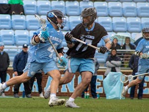 UNC graduate attackman Chris Gray (4) looks for an open pass during a men's lacrosse game on Sunday, Feb. 27, 2022, against Johns Hopkins University.