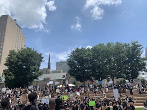 Protestors stand on the steps of Winston Square Park during a protest against police brutality on Saturday, June 6, 2020.