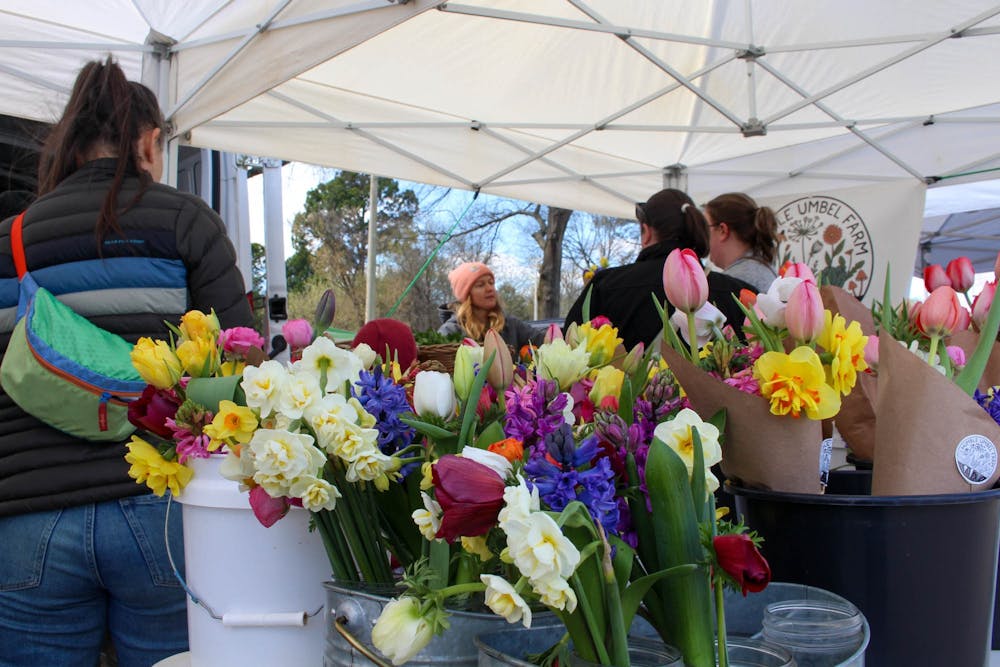 <p>Anna Alexandre, a co-founder of Humble Umbel Farm, interacts with customers on Saturday, March 11, 2023, at the Chapel Hill Farmers Market.&nbsp;</p>