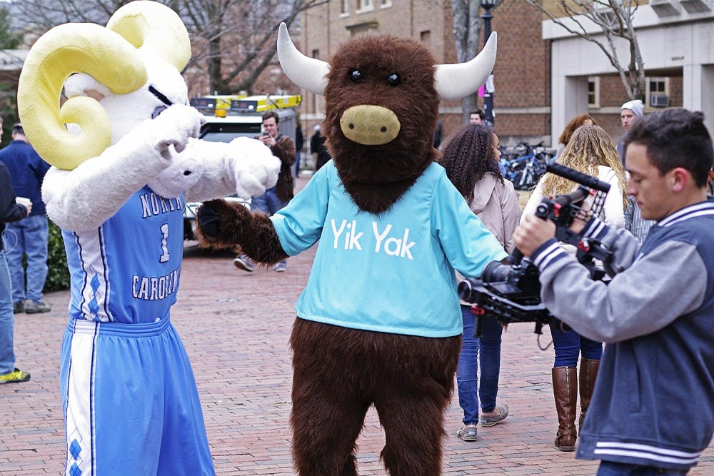 Rameses and the Yik Yak mascot dance in front of Lenoir Hall on Tuesday. Yik Yak  filmed a promotional video for their spring campus tour.