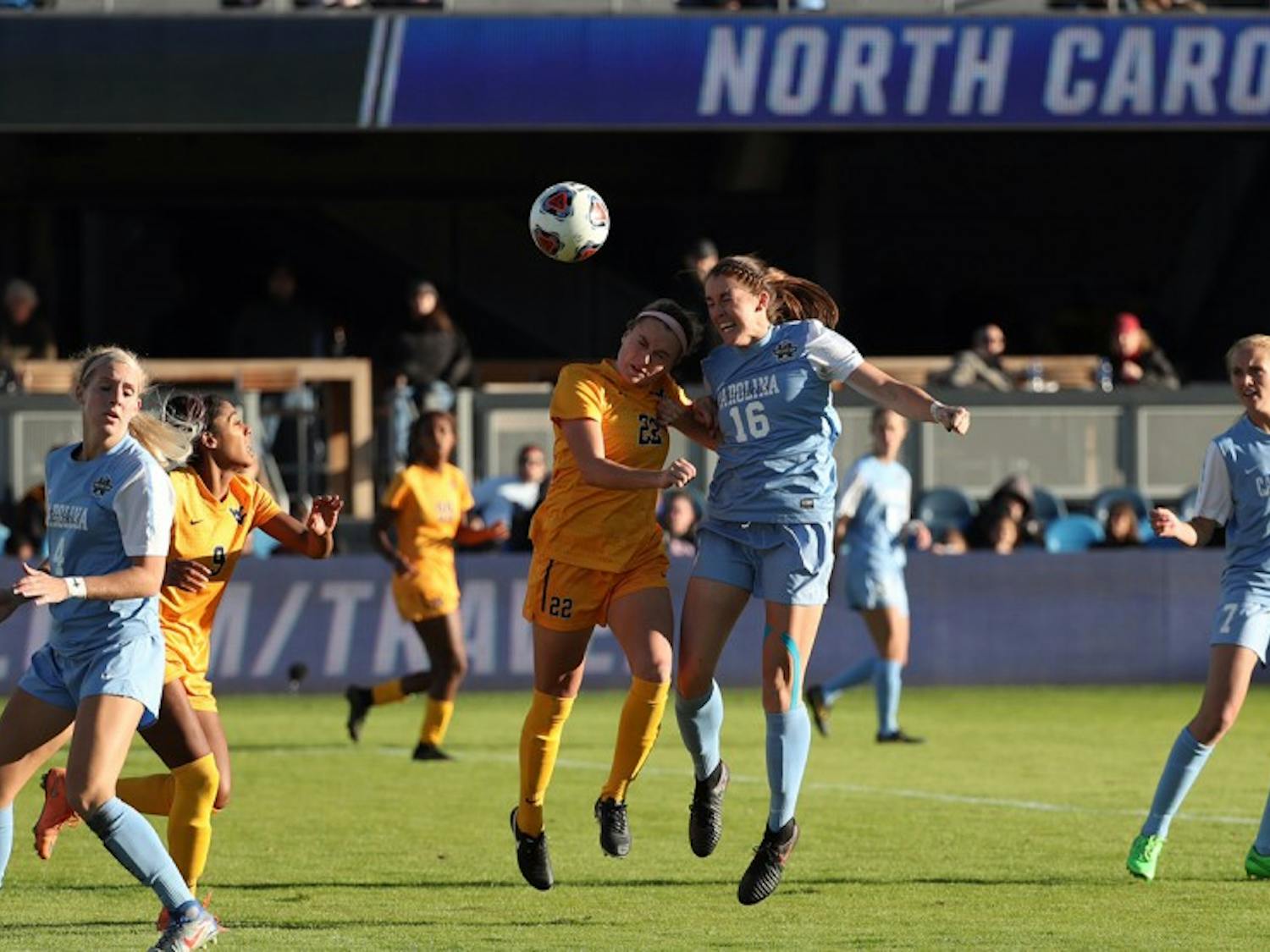 Sophomore defender Julia Ashley (16)&nbsp;goes up for a header against&nbsp;West Virginia on Friday. The Tar Heels fell 1-0 in the NCAA semifinal.&nbsp;