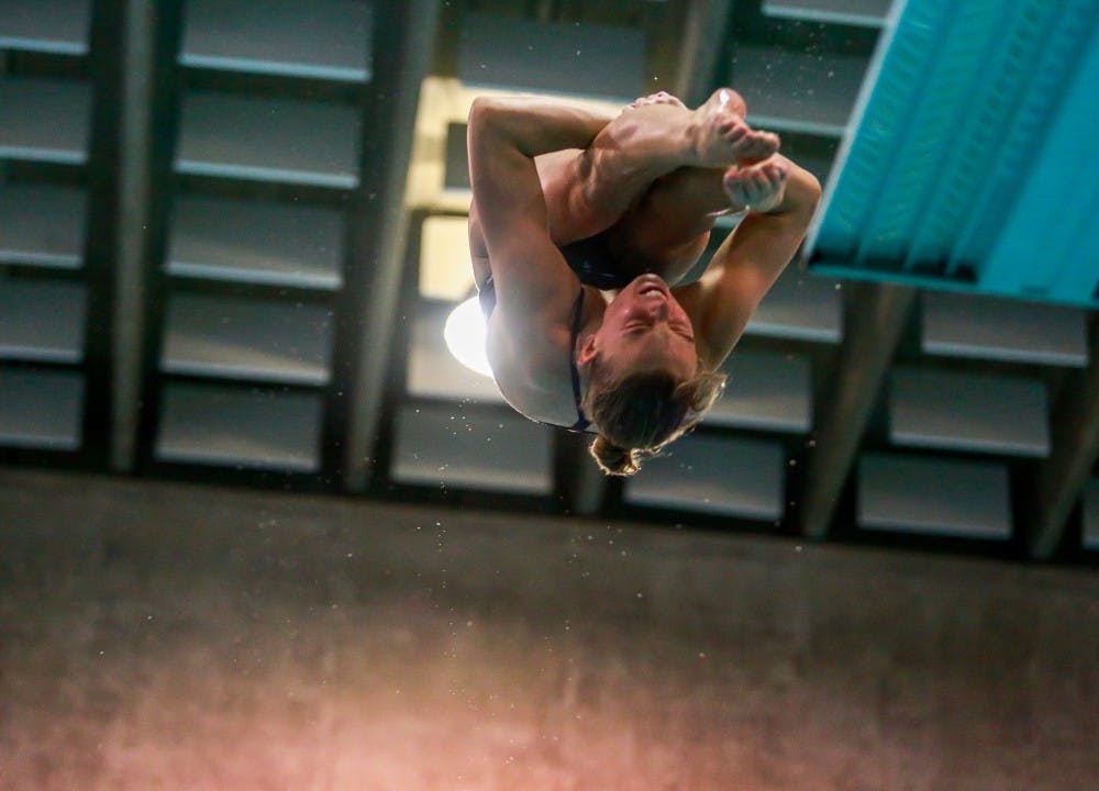 Emily Grund dives during the home swim and dive meet vs. Duke in Koury Natatorium on Saturday, Feb. 2, 2019.