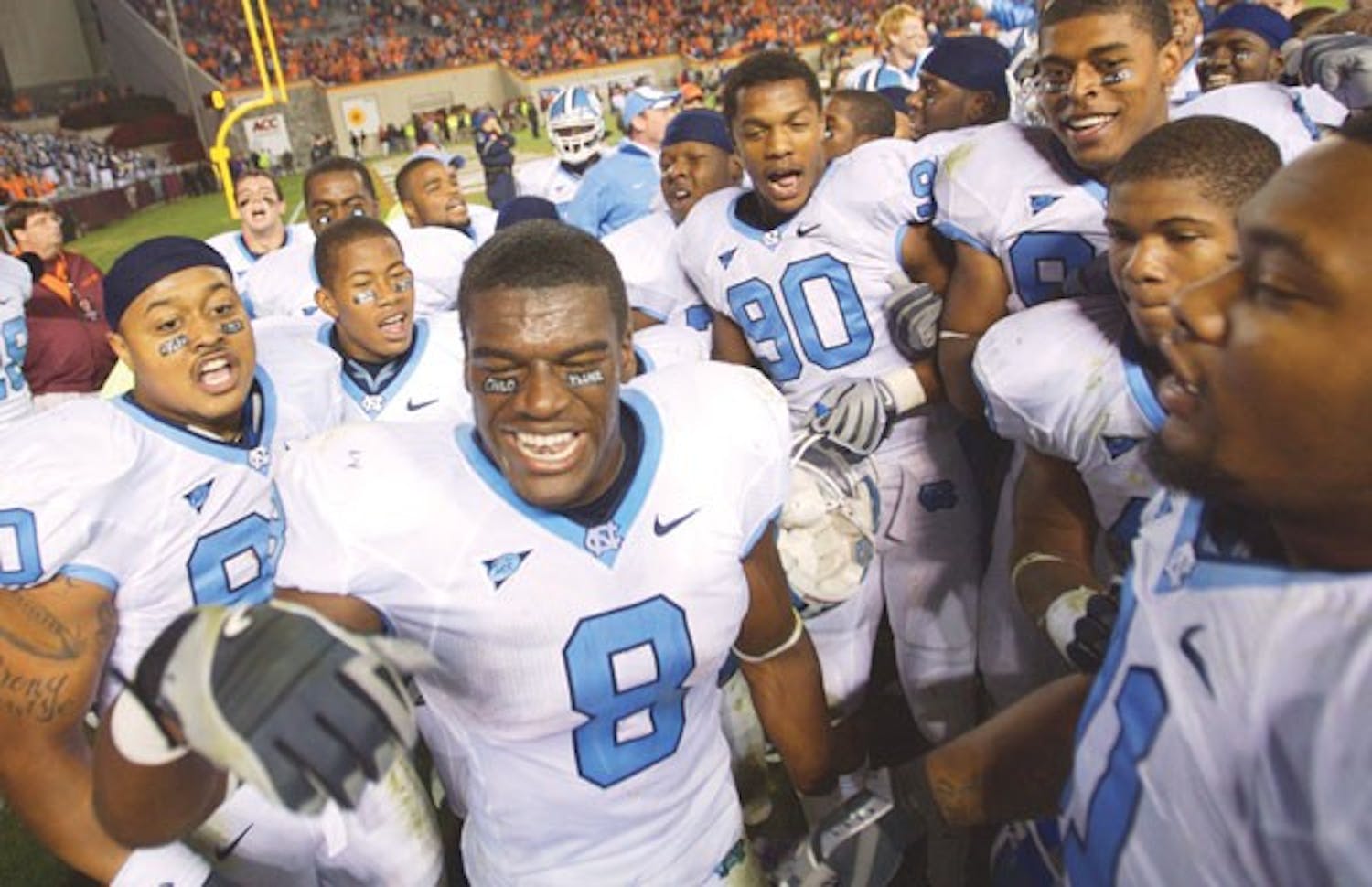 Greg Little (8) and members of North Carolina’s football team celebrate after UNC upset No. 14 Virginia Tech. DTH/Andrew Dye