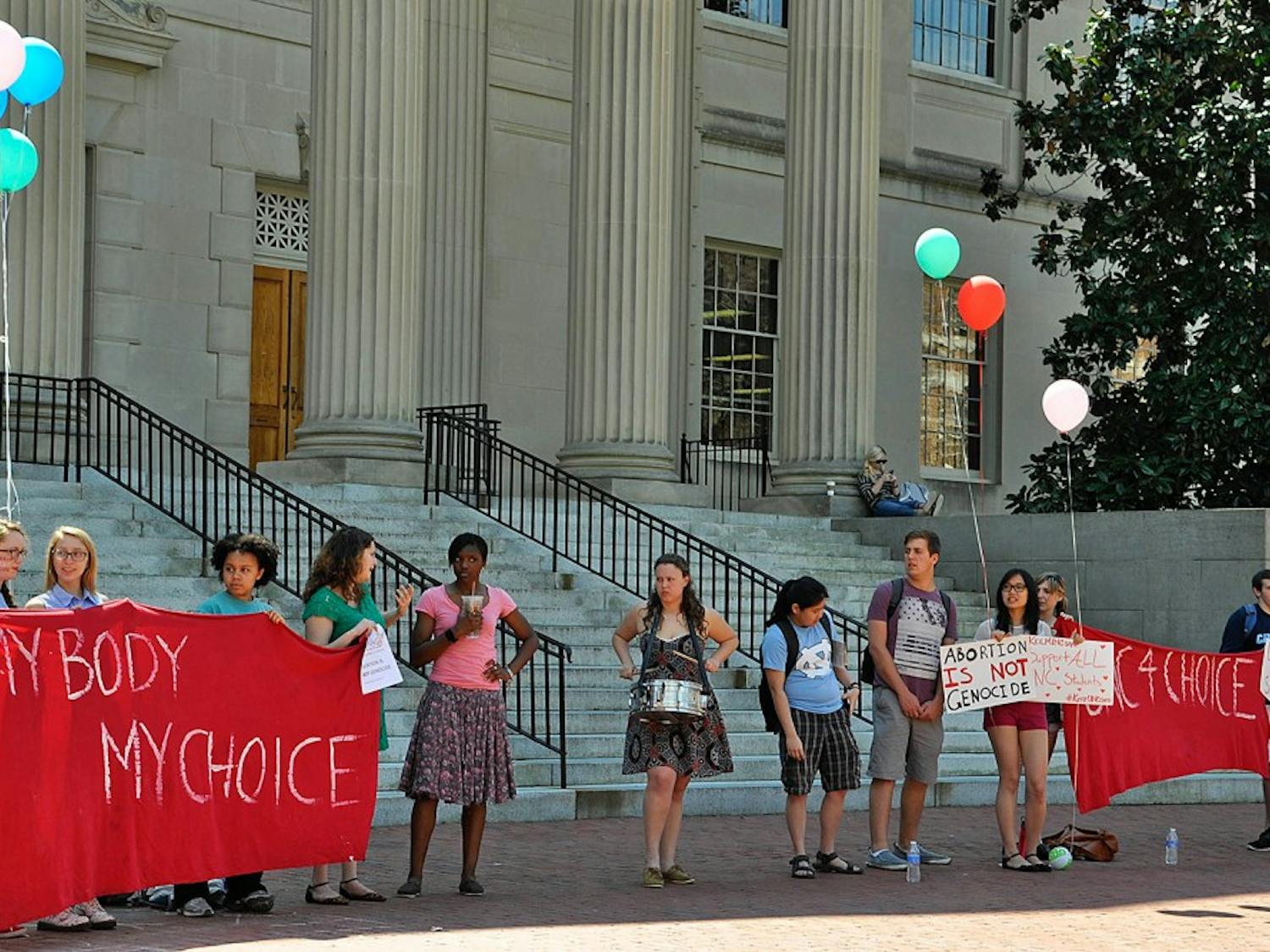 Students from different organizations gathered in front of Wilson Library to form a human chain and to protest the anti-abortion displays.