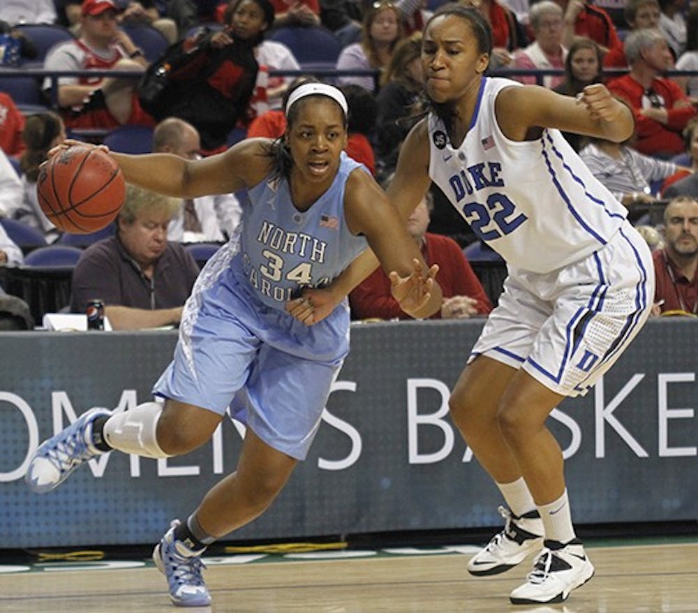 	Xylina McDaniel (34) drives to the basket during an ACC tournament game. 