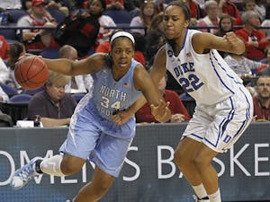 	Xylina McDaniel (34) drives to the basket during an ACC tournament game. 