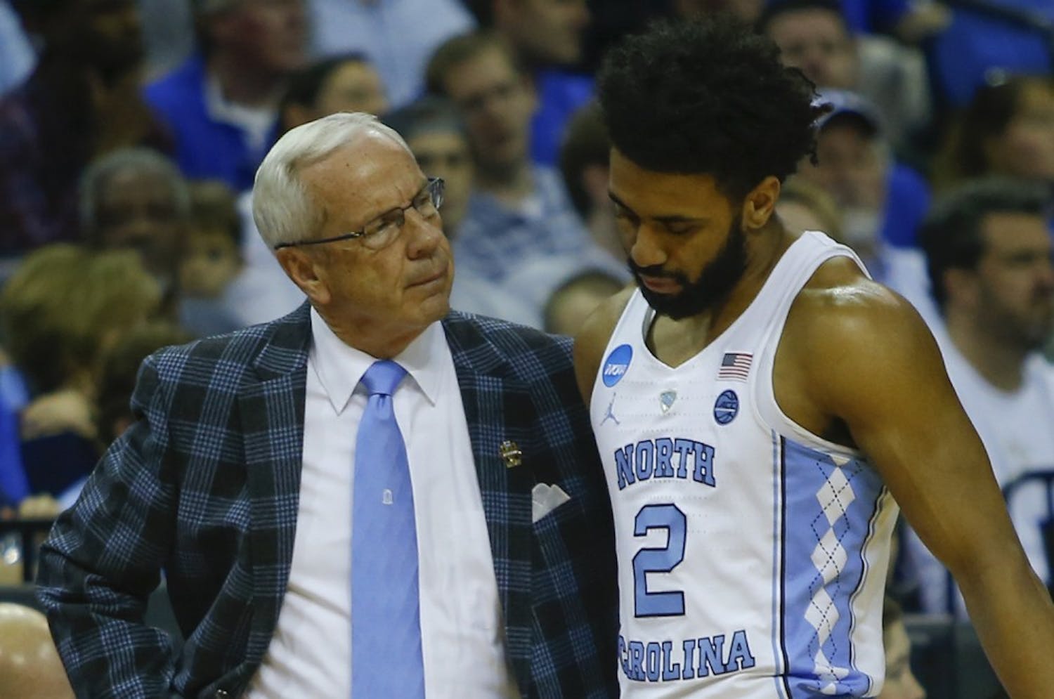 North Carolina guard Joel Berry (2) is met by Coach Roy Williams after injuring his ankle in the first half of Sunday's Elite Eight matchup against Kentucky in Memphis.