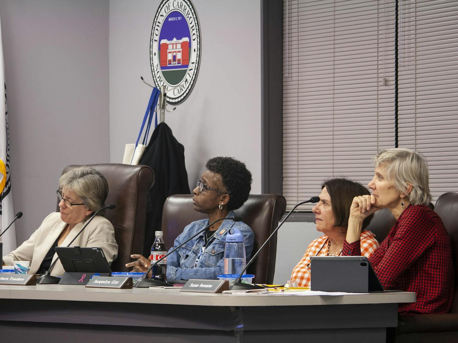 (From left) Carrboro Mayor Lydia Lavelle and Council Members Barbara Foushee, Jacquelyn Gist and Susan Romaine listen to residents speak about UNC's coal plant on Feb. 4, 2020. A resolution calling for UNC to cease operations of this plant has been proposed to the Town Council and is an ongoing debate.
