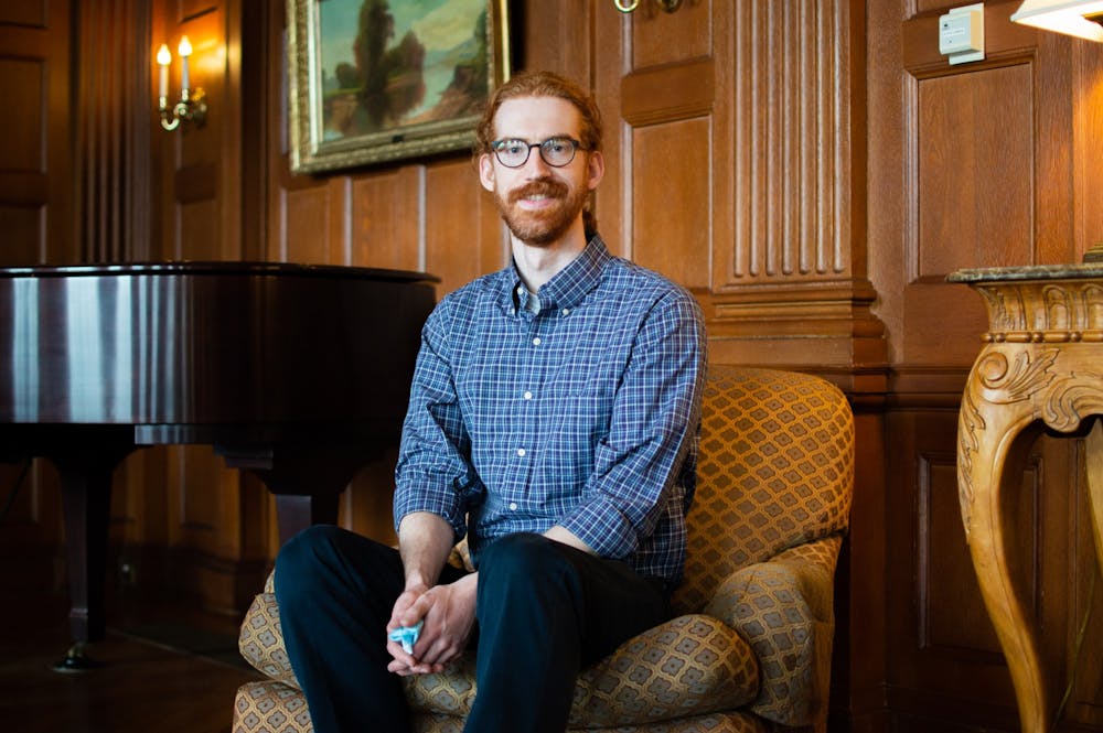 Theodore Nollert, a third-year PhD student in the English and Comparative Literature Department, has been elected president of the Graduate and Professional Student Government. He smiles for a portrait inside Graham Memorial Hall on Feb. 17, 2022.