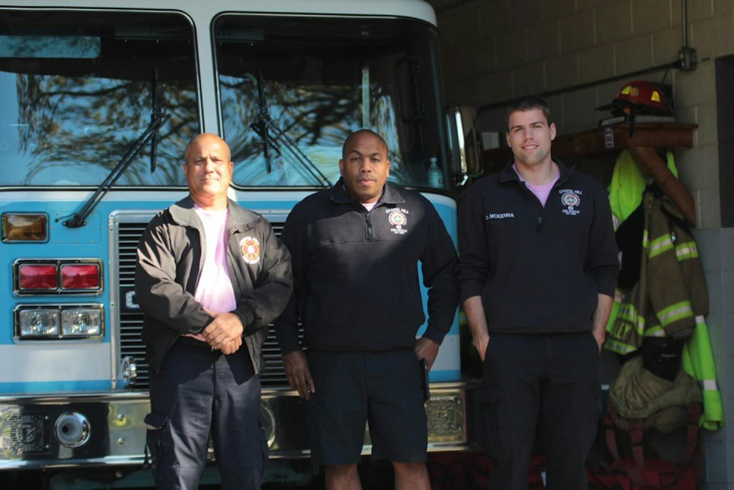 Chapel Hill Firefighters Richard Bucci (left), Devin McKenna (right) and Fire Equipment Operator Keith Alston (middle) pose at Chapel Hill Fire Station 2.&nbsp;