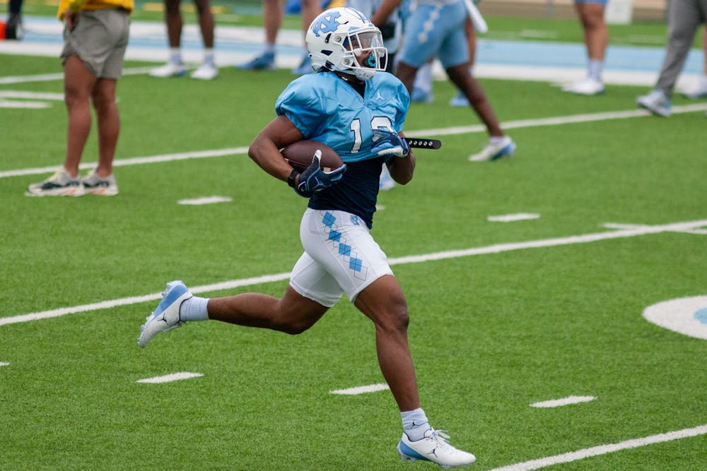 Graduate student transfer running back Ty Chandler (19), runs with the ball at the football practice on Saturday Mar. 27, 2021 at Kenan Stadium.