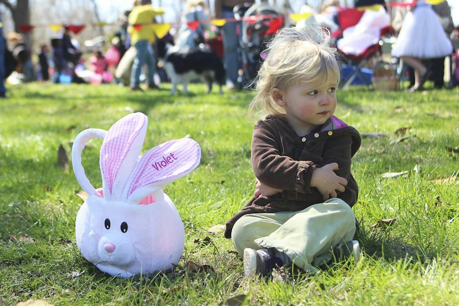 Violet Strickland of Hillsborough sits with her egg basket after the conclusion of Saturday’s egg hunt at River Park in Hillsborough. She found one egg.