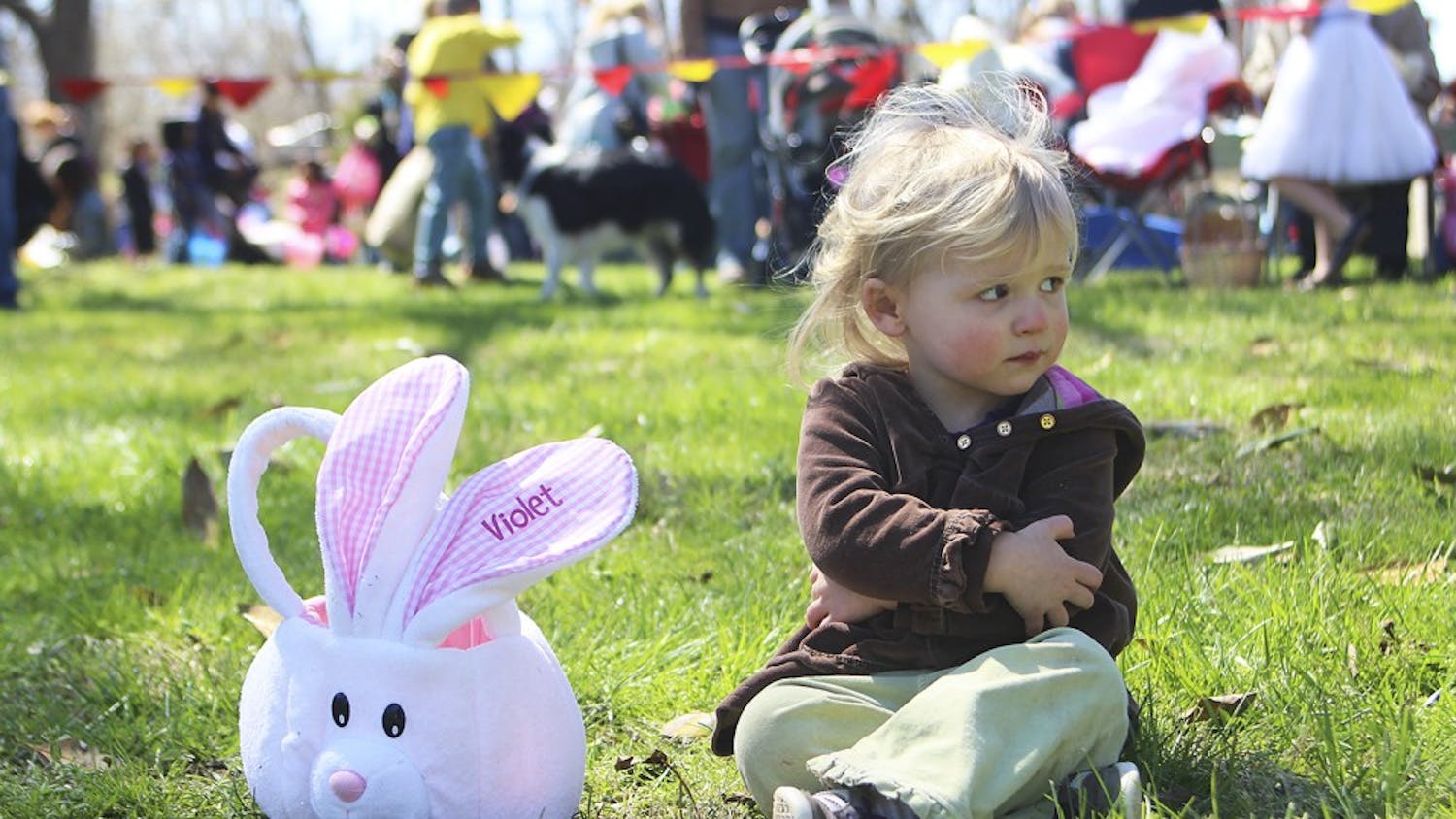 Violet Strickland of Hillsborough sits with her egg basket after the conclusion of Saturday’s egg hunt at River Park in Hillsborough. She found one egg.
