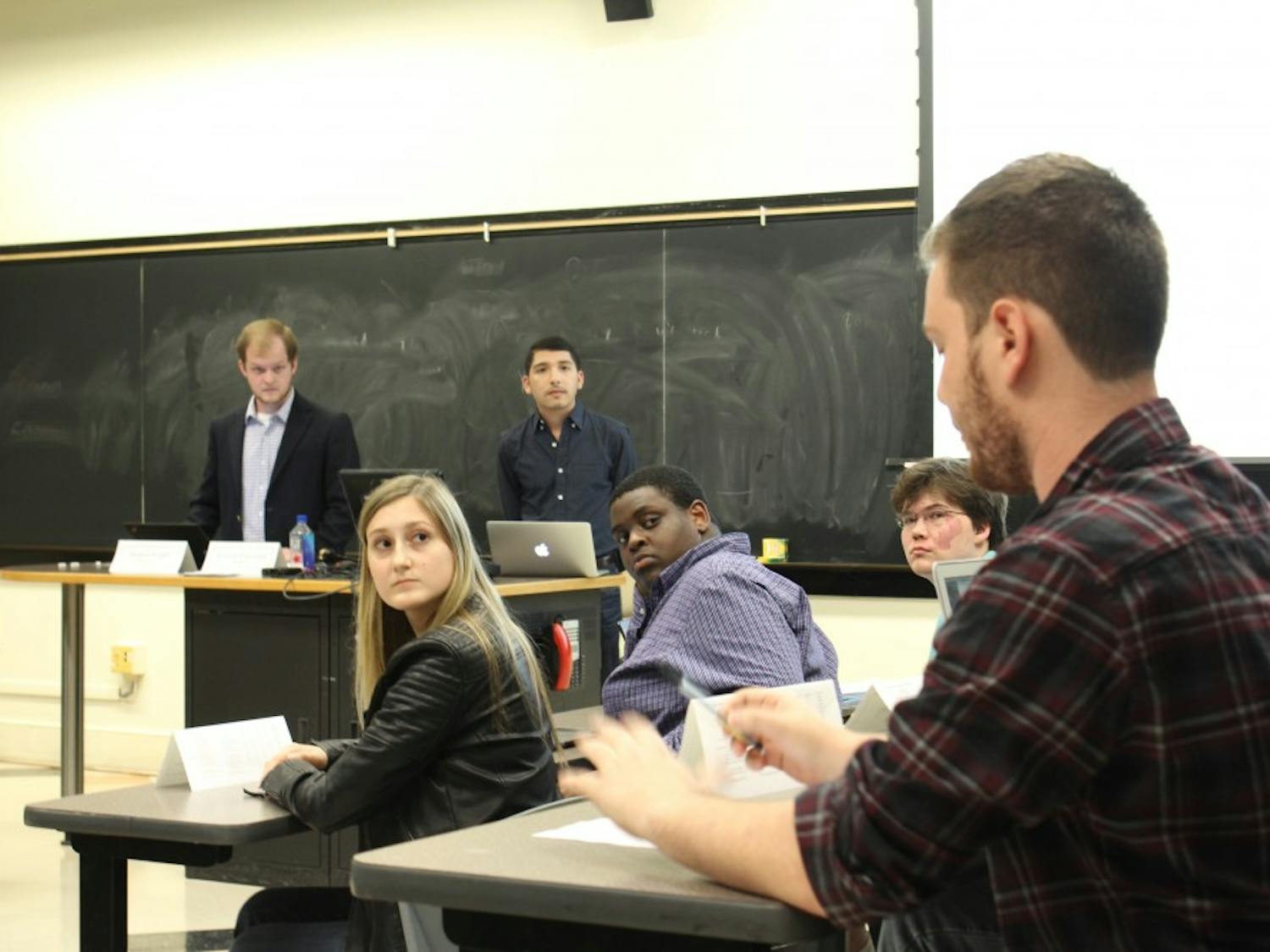 Senator Oliver Mitchell (far right) addresses the full Undergraduate Senate about the process that led to Senator Sosa Evbuomwan's failed nomination to the Student Advisory Committee to the Chancellor Tuesday, Oct. 16, 2018 in Gardner Hall.