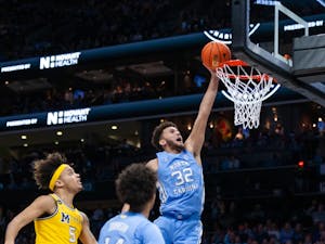 UNC graduate forward Pete Nance (32) dunks the ball during the men's basketball game against Michigan at the Jumpman Invitational in Charlotte, N.C., on Wednesday, Dec. 21, 2022. UNC beat Michigan 80-76.
