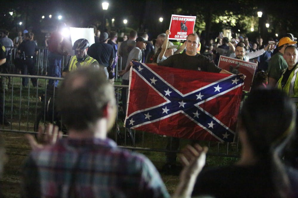 Demonstrators proudly displayed a Confederate flag and counter-protestors chanted in response on McCorkle Place Thursday night.