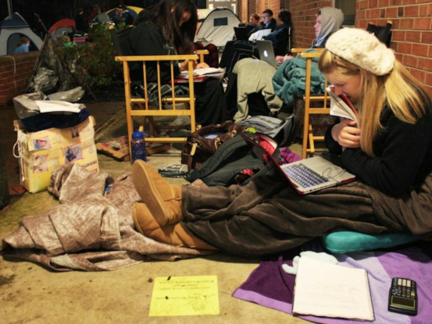 Students camp out and line up for various suites on campus. Some have been at Morrison since last Wednesday night. Lauren Spoeneman, a freshman Psychology major, does work while camped out in front of Morrison. She wants a room in Teague and has been there since 11 AM Monday. 