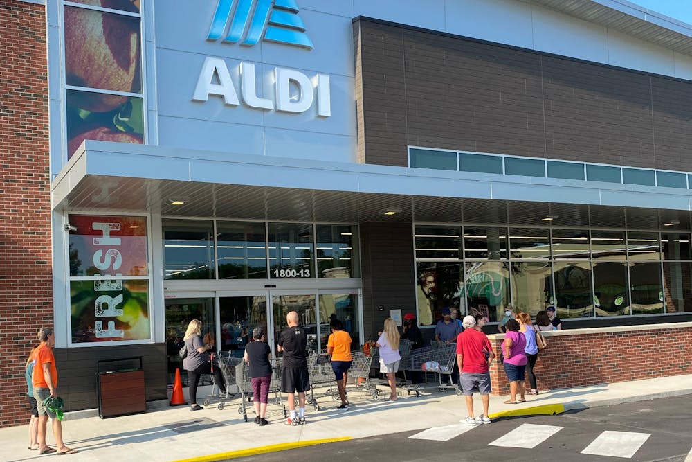<p>Customers wait in line to shop at Aldi on opening day, Aug. 3 2022.</p>