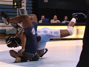	Thomas Ferguson earns a major decision against Kenneth Radford, bringing the Tar Heels within two points. The extra point Ferguson won with the major decision ended up being the difference in UNC’s 19-18 victory.