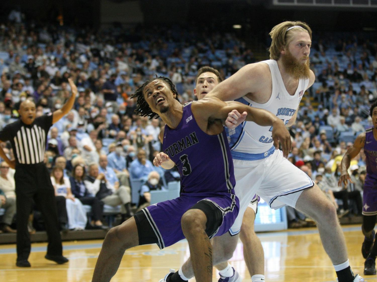 UNC graduate forward Brady Manek (45) fights for position under the basket during a home game at the Dean Smith Center against Furman on Tuesday, Dec. 14, 2021.