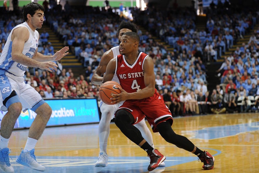 N.C. State's Dennis Smith (4) drives to the basket during the game against UNC on January 8.&nbsp;
