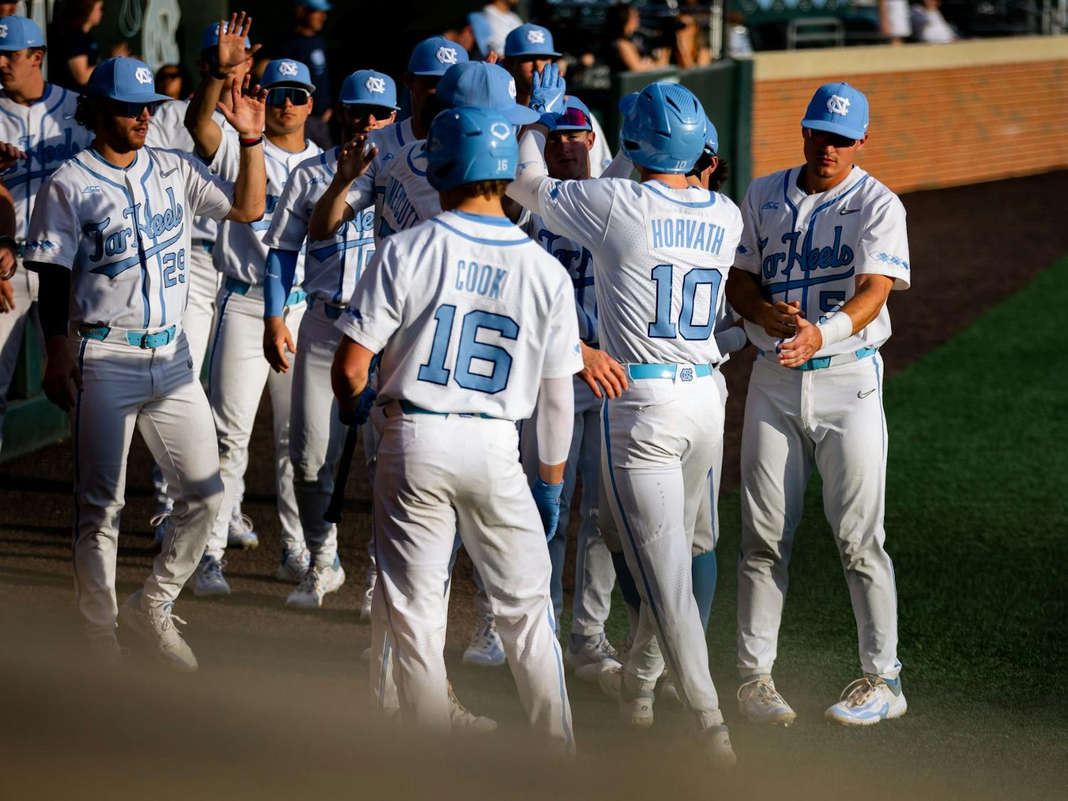 UNC junior infielder Mac Horvath (10) scores off a single by UNC junior catcher Tomas Frick (52) in the first inning of the baseball game against Duke at Boshamer Stadium on Friday, March 24, 2023. UNC fell to Duke 8-5.
